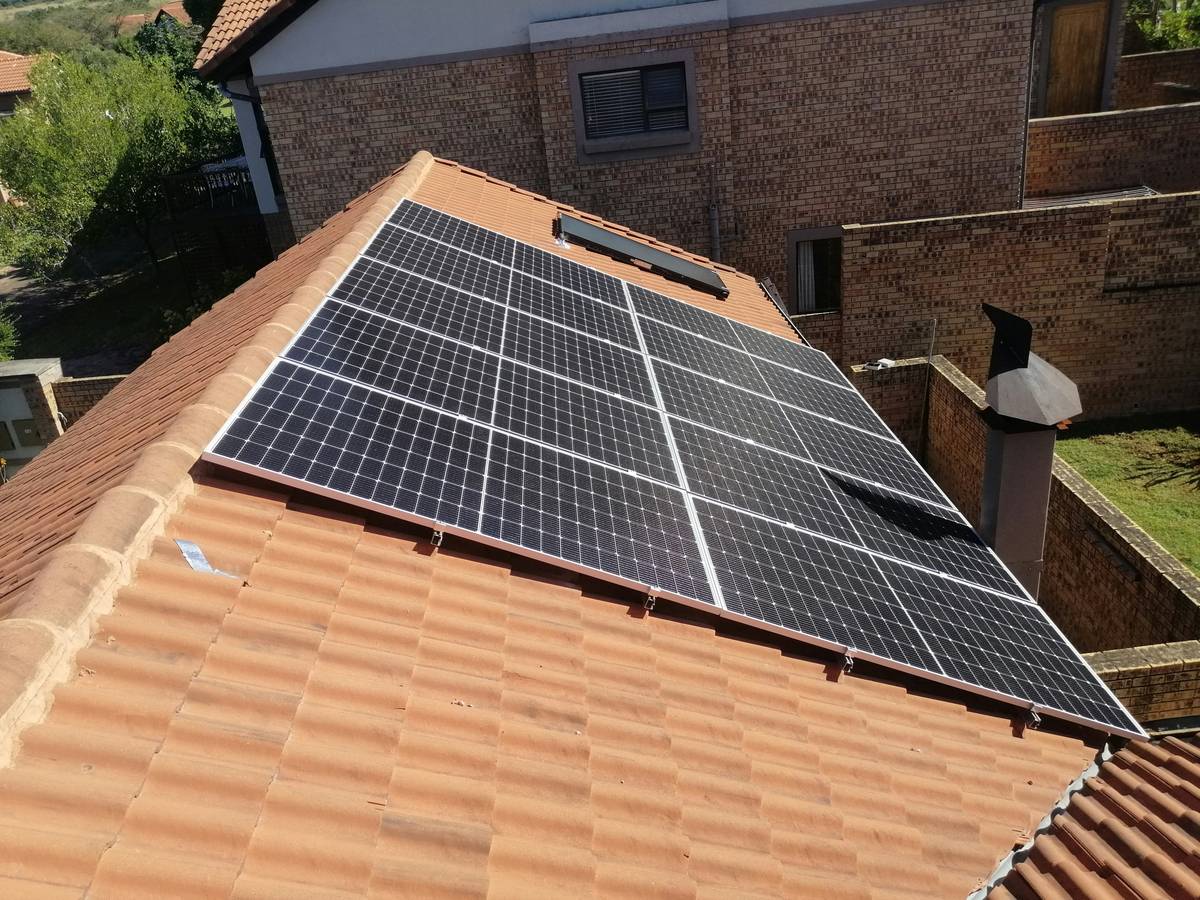 solar energy panels home benefits: correctly wired residential rooftop solar array with labeled DC conduits and junction boxes